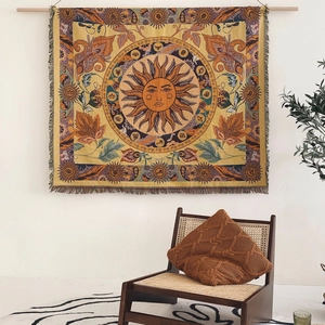 Retro sun and zodiac tapestry with tassels hanging on a wall in a cozy home setting