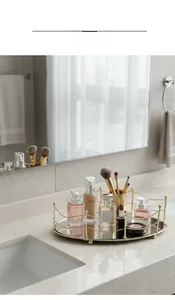 Detail showing gold geometric metal frame and black mirrored base of the luxury vanity tray