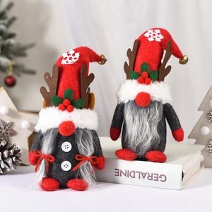 Detail of Christmas gnomes with reindeer antlers on decorative books with pine cones