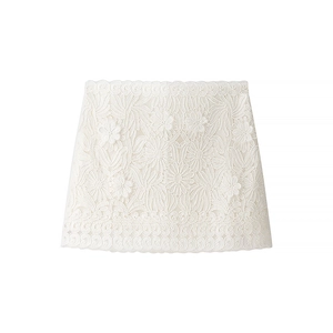 Intricate floral lace embroidery detail on a feminine ivory white two-piece skirt set