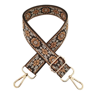 Detail of 3.8cm ethnic floral embroidery strap with golden metal buckle and slider