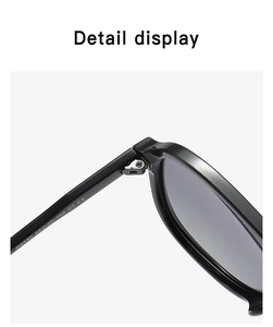 Detail view of reinforced metal hinge and printed model specs on black polarized sunglasses