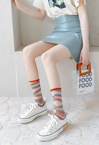 Detail of sheer striped women's mid-calf socks with Japanese style beige transparent texture