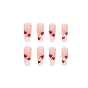 Long coffin press-on nails with nude base, white French tips and red glitter hearts