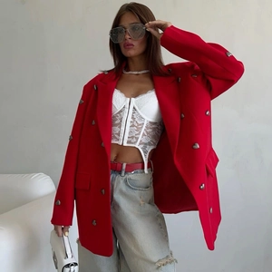 Detailed shot of a red oversized blazer with decorative silver heart-shaped metal buttons