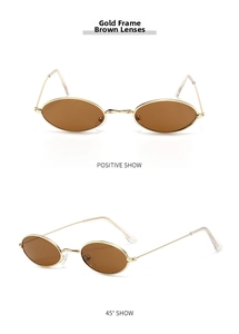 Detail view of oval small frame sunglasses with gold metal frame and tea colored lenses