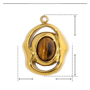 Macro detail of gold stainless steel marquise pendant with natural tiger eye stone inlay