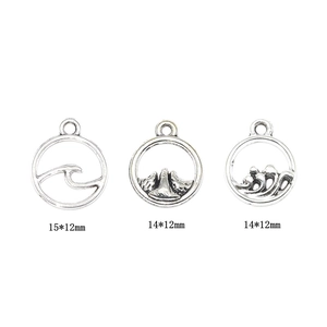 Antique silver circular pendants with mountain and wave motifs in various sizes
