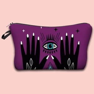 Purple waterproof Evil Eye makeup bag with zipper and stars pattern on pink background