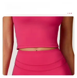 Detail of rose pink yoga top showing high-elasticity fabric and waist-slimming fit