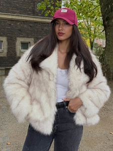 Close-up of white faux fox fur jacket texture with a premium soft fluffy material finish
