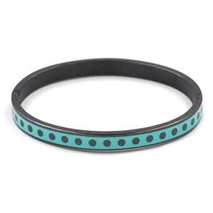 Detail of tiffany blue and black polka dot pattern on stainless steel bangle