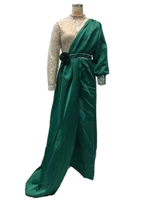 Detail of emerald green satin dress featuring gold sequins and floral waist decoration