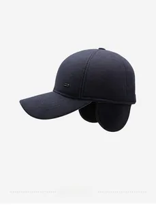 Detail view of winter baseball cap for men featuring warm ear flaps and navy wool texture