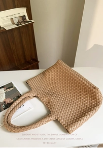 Detail of the woven texture and classic light brown checkered pattern of the tote bag