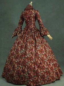 Detail view of Victorian dress featuring deep red paisley print and ruffled sleeve cuffs