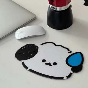 Close-up of a cute cartoon-shaped non-slip mouse pad on a modern white office desk