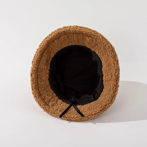 Inside view of brown lamb wool bucket hat featuring adjustable inner black drawstring