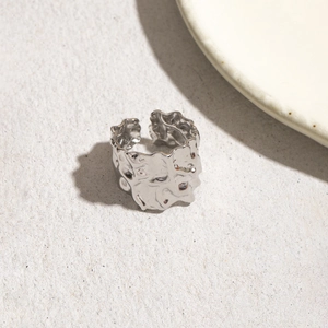 Detail of minimalist irregular texture open ring with metallic silver lava finish