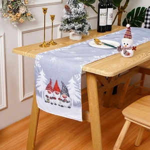 Christmas table runner with cute cartoon gnomes and snowflake pattern on wooden table