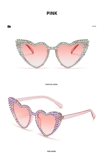 Detail of heart-shaped sunglasses with colorful rhinestones and pink gradient lenses