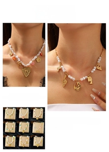 Detail of vintage stainless steel pearl necklaces with heart and bow-tie pendants