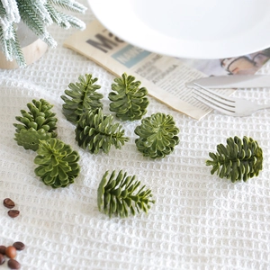 Set of 8 green artificial plastic pine cones for creative Christmas table decorations