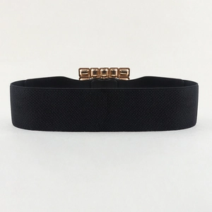 Detail of a 6cm wide black elastic belt featuring a textured golden rectangular metal buckle