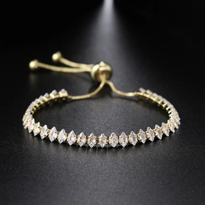 Macro shot of gold-plated marquise-cut tennis bracelet with adjustable bolo slide clasp