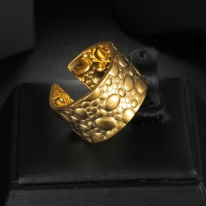 Golden wide open ring featuring a unique 3D irregular pebble texture on stainless steel