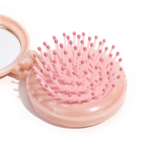 Pink portable marble patterned folding hairbrush with mirror for compact travel use