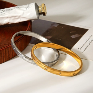 Luxurious striped stainless steel bracelets in gold and silver with sparkling diamonds