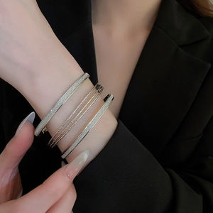 Set of 4 silver multilayer bracelets featuring frosted texture and twisted rope details