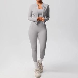 Detail of grey three-piece yoga set featuring high-waisted leggings with side pockets