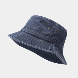 Macro detail of washed denim bucket hat showing metal eyelets and reinforced stitching