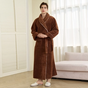 Thick brown coral fleece bathrobe for men with white trim and waist tie in home setting