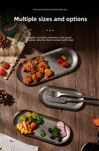 Macro detail of three vintage matte 304 stainless steel oval plates with food on dark wood