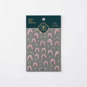 Pink lace and bow nail art stickers with dreamy star patterns in green gold packaging