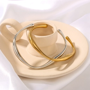 Minimalist wavy irregular open bangle set in gold and silver finish with polished surface