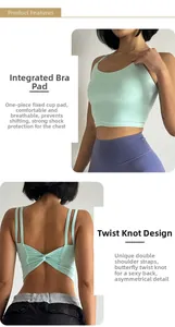 Detail view of mint green sports bra with fixed pads and cross-strap twist back design