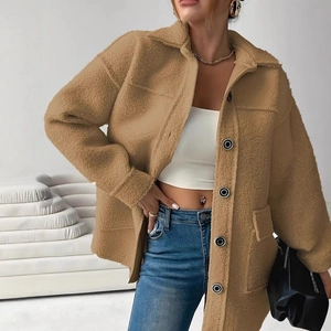 Side view of woman wearing a thick camel faux fur jacket with large pockets and buttons
