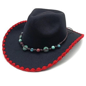 Detail of black felt fedora featuring red braided edge and ethnic beaded hatband