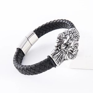 Men's black braided leather bracelet featuring a detailed silver lion head charm with magnetic clasp
