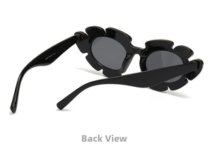 Detail view of the black flower-shaped sunglasses frame and wide temples in a folded position