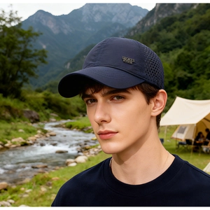 Close-up of a navy sports cap with mesh side panels and metal plate in an outdoor setting