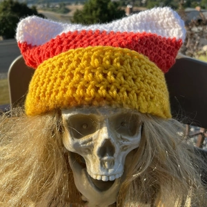 Detailed knit texture of handmade tricolor cat ear hat with devil horns for women