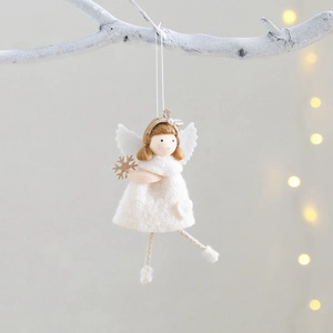 White plush Christmas tree angel ornament with gold crown on a festive branch