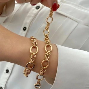 Handmade gold chunky chain bracelet with large oval links and woven texture detail