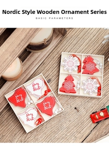 Close-up of red and white wooden Christmas tree ornaments with bells in a wooden box