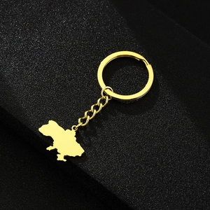 Macro view of gold-plated Ukraine map pendant on a sleek black matte background